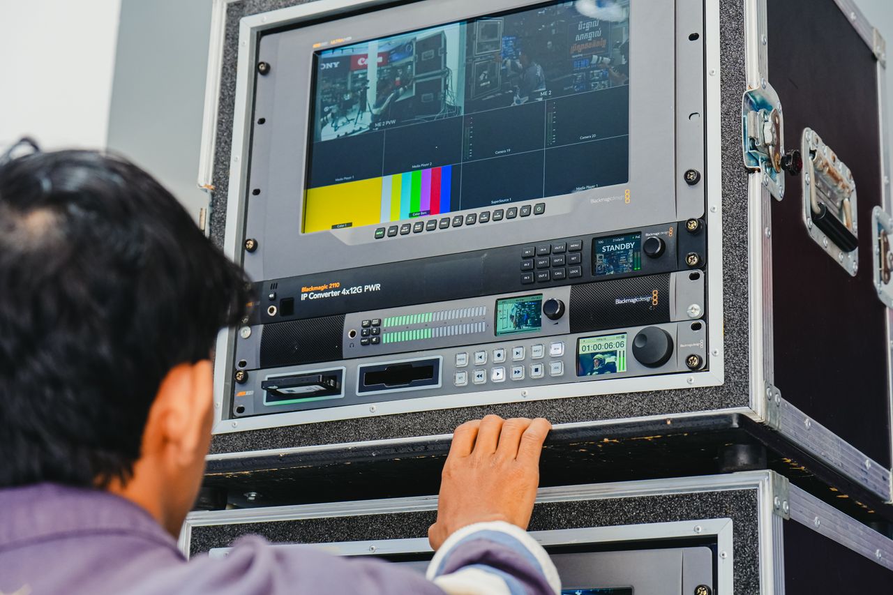 Crafting Captivating Headlines: Your awesome post title goes here A technician manages professional broadcasting equipment in a control room setting.